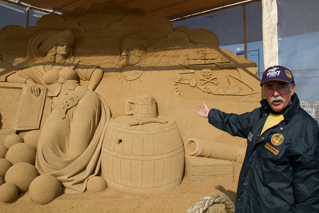 Othmar Schiffer-Belz vor der Sandskulptur „Die Piratenbraut von Störtebeker“ von Vyacheslav Borecki in der 3. Warnemünder Sandwelt 2012